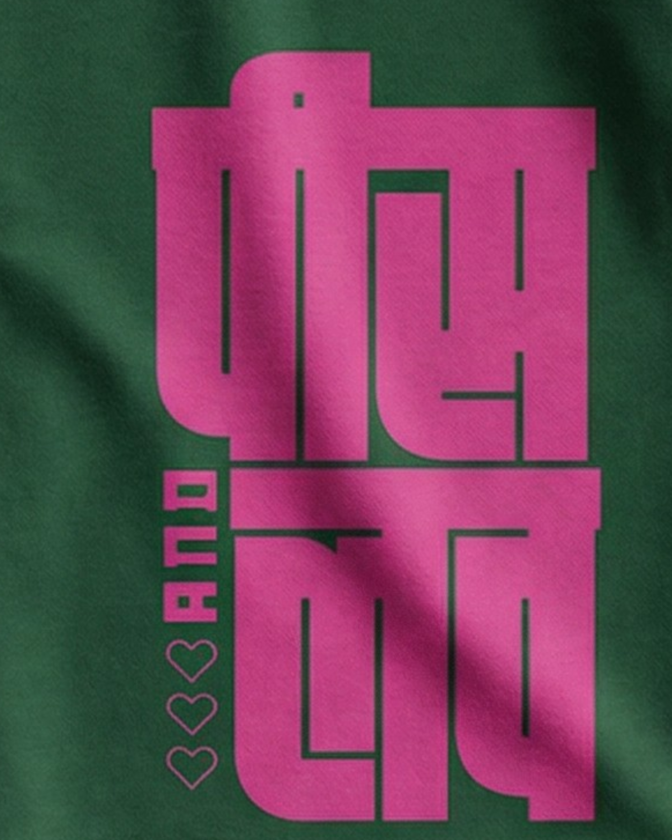Green t-shirt with pink text and heart designs on a white background